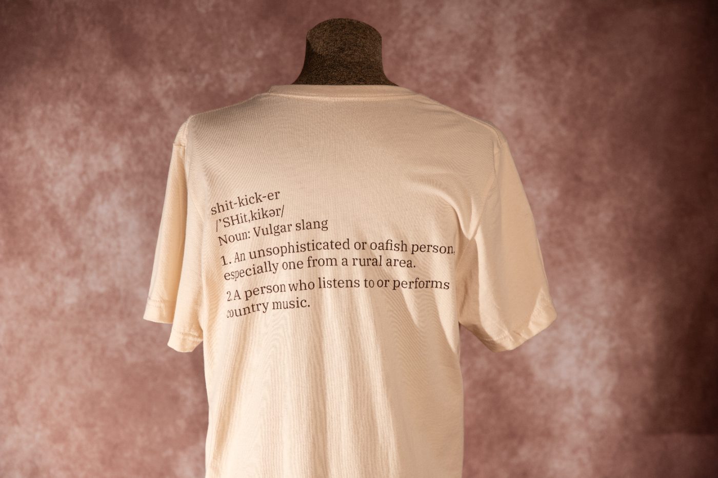 Back of the Shit Kicker tee showing the printed definition